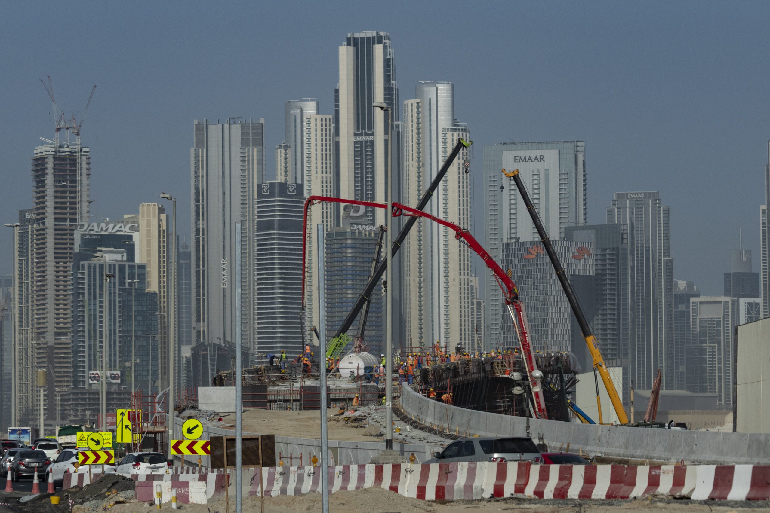 A construction site with skyscrapers towering in the background in Dubai, United Arab Emirates, August 13, 2024. (AP Photo/Altaf Qadri)