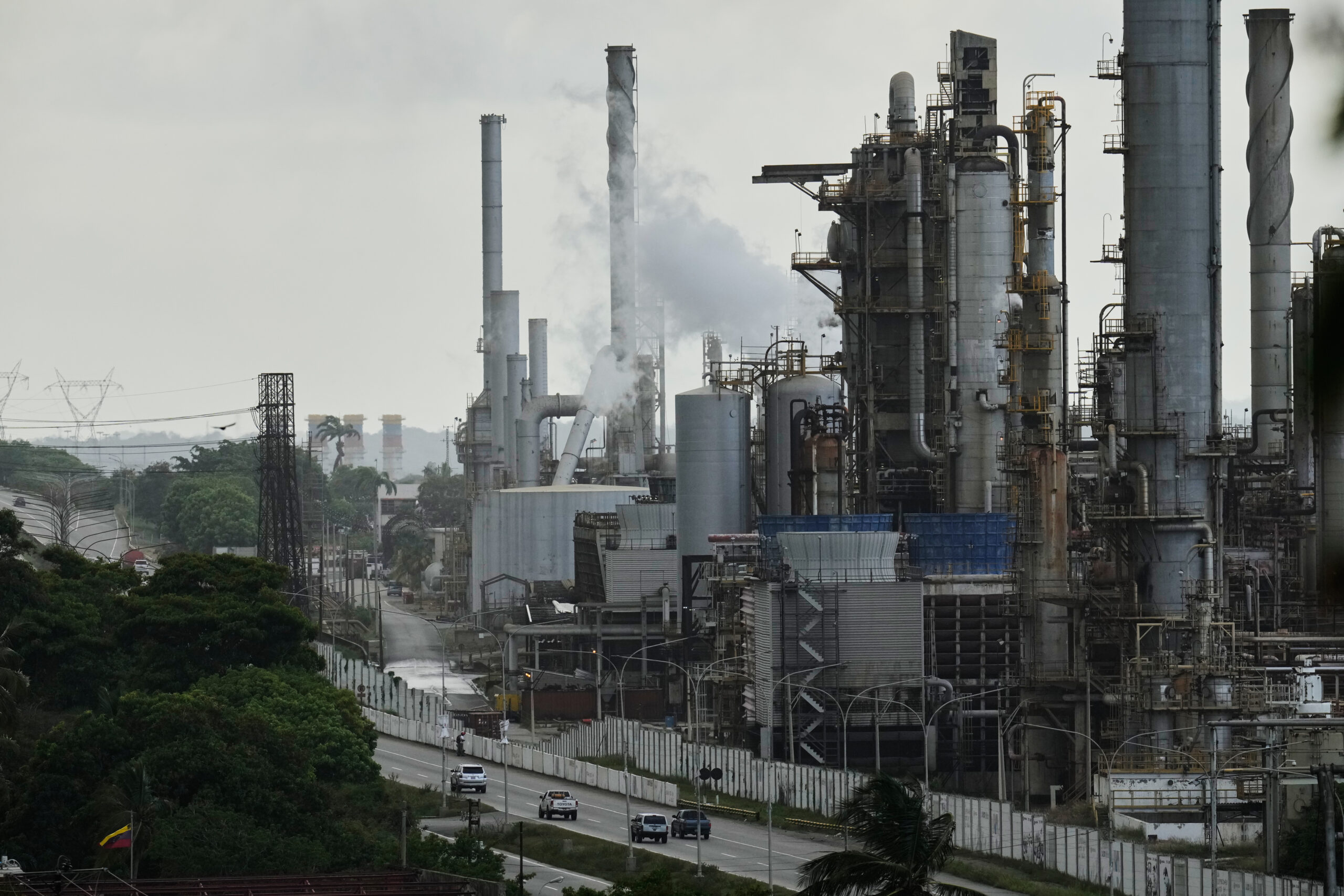 Vehicles drive past the El Palito oil refinery in Puerto Cabello, Venezuela, Dec. 21, 2025. (AP Photo/Matias Delacroix, File)
