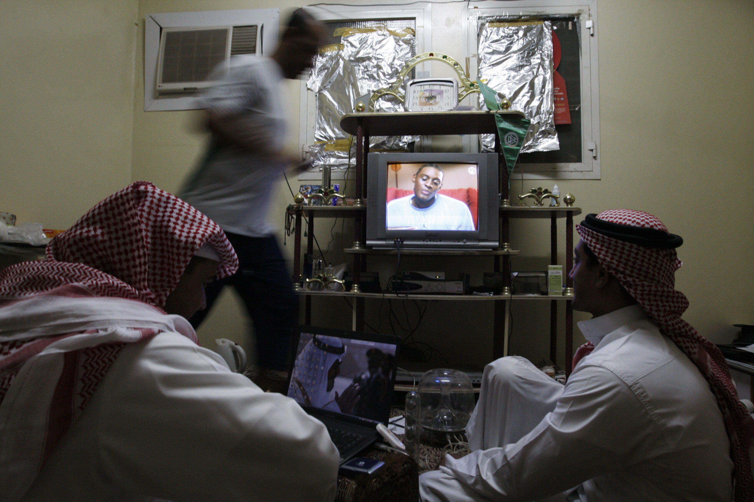 Saudi men watch satellite television at home in Riyadh, Saudi Arabia, Sept. 16, 2008. (AP Photo/Hassan Ammar)