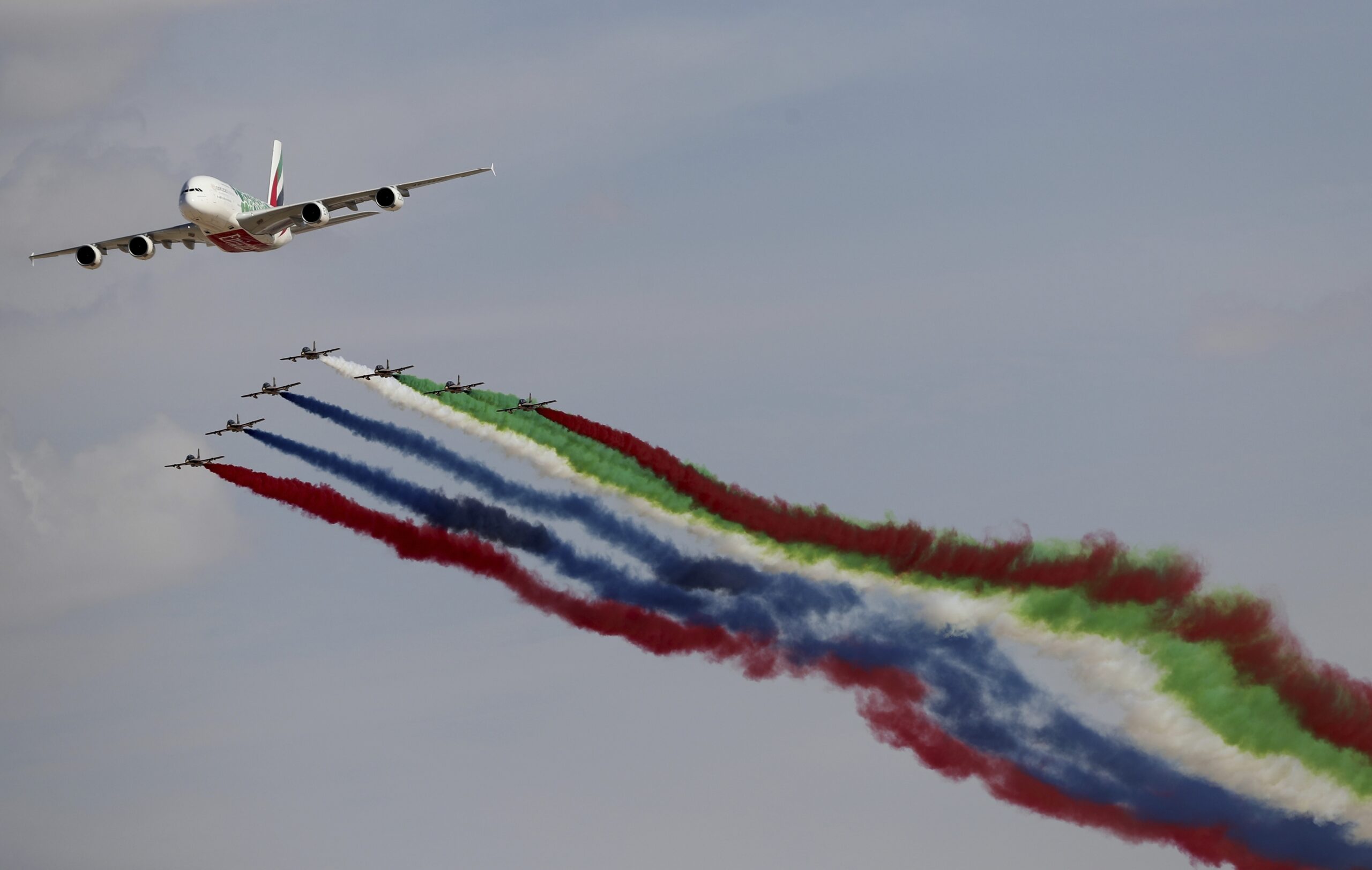 An Emirates Airlines A-380 leads the "Al Fursan," or the Knights, an Emirati air force aerobatic display team during the opening day of the Dubai Airshow, Nov. 17. (AP Photo/Kamran Jebreili)