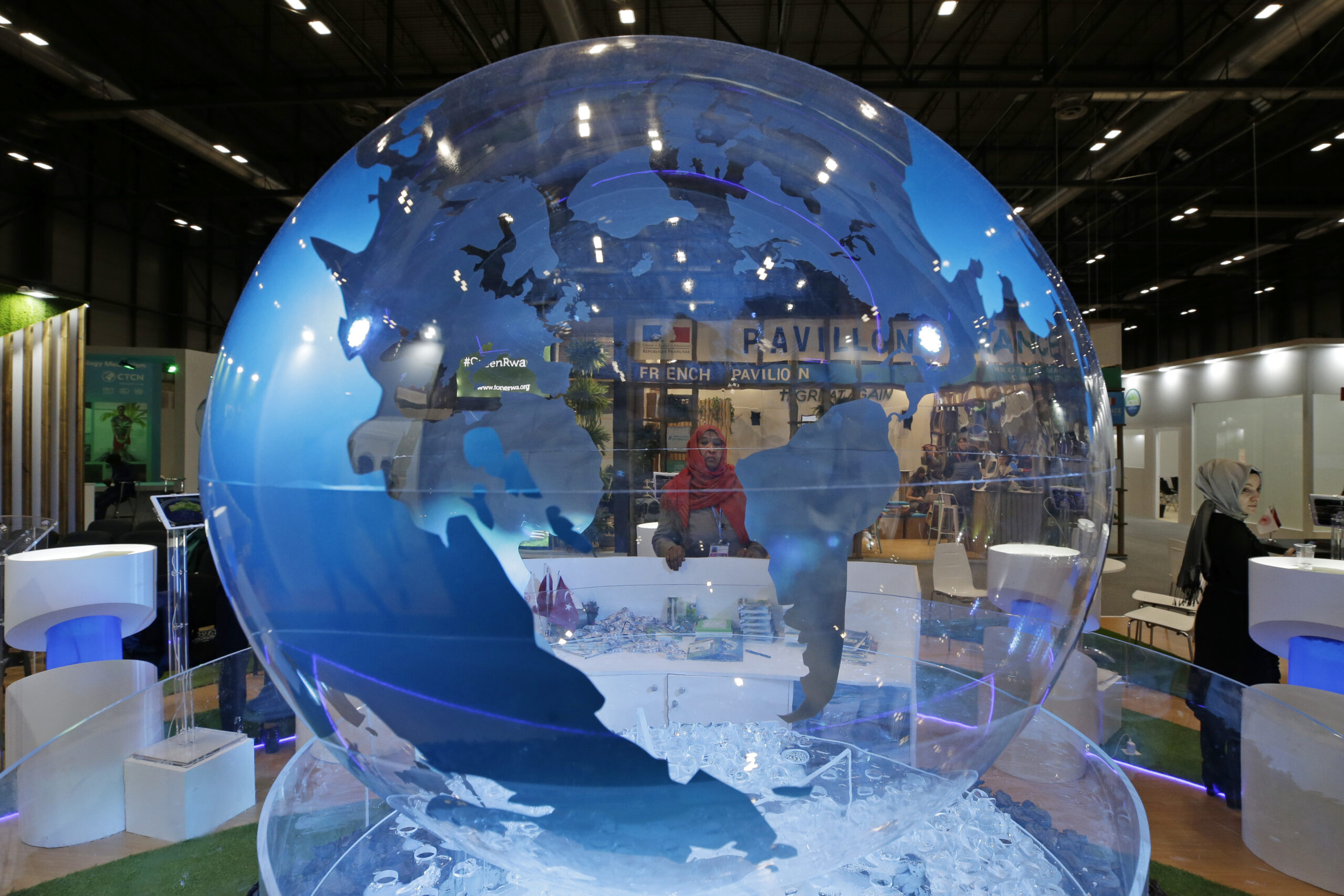 A woman looks at a globe at the COP25 climate talks congress in Madrid, Spain, Dec. 13. (AP Photo/Paul White)