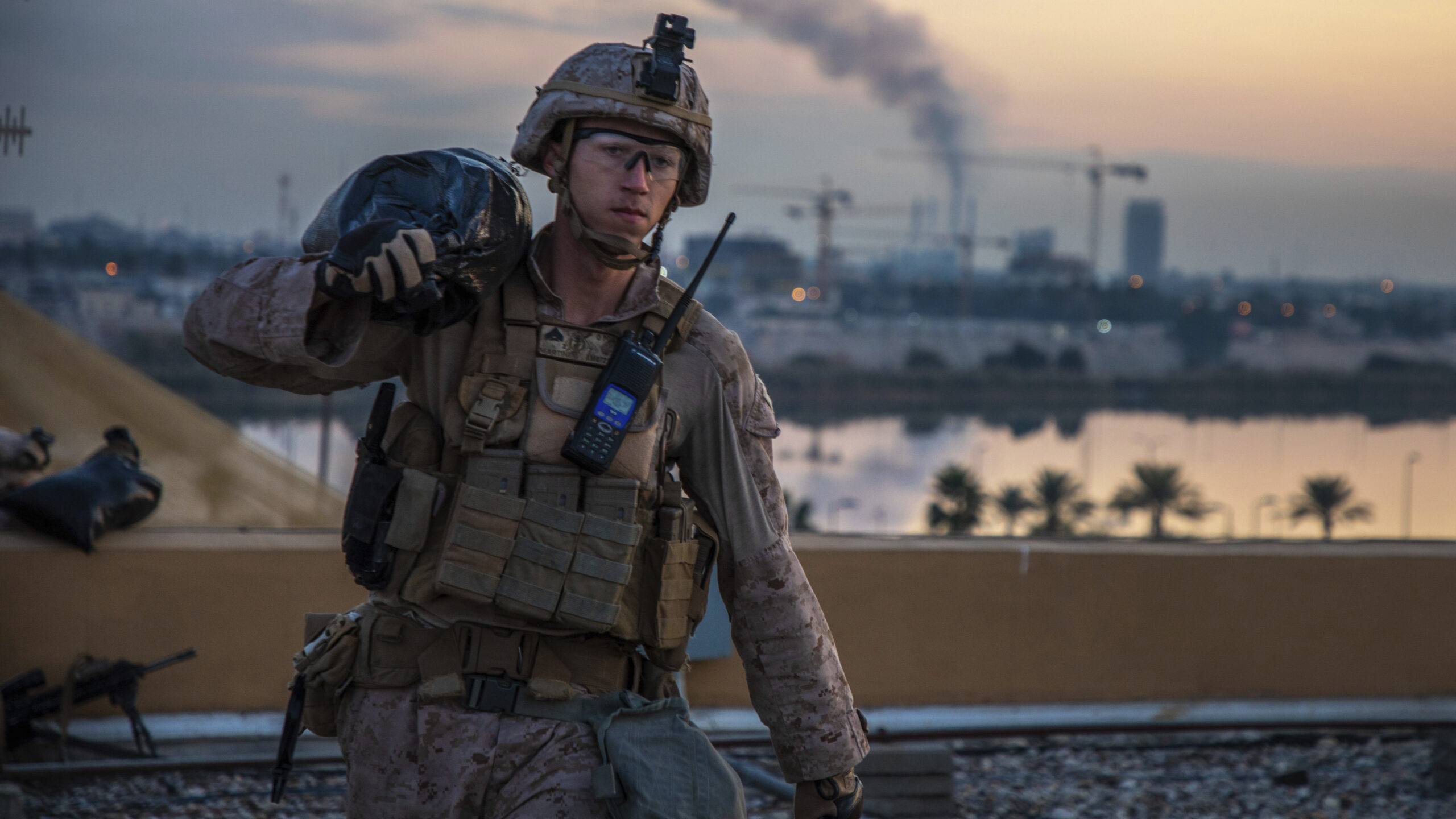 A U.S. Marine carries a sand bag during the reinforcement of the U.S. Embassy compound, Baghdad, Iraq, Jan. 4. (U.S. Marine Corps photo by Sgt. Kyle C. Talbot via AP)