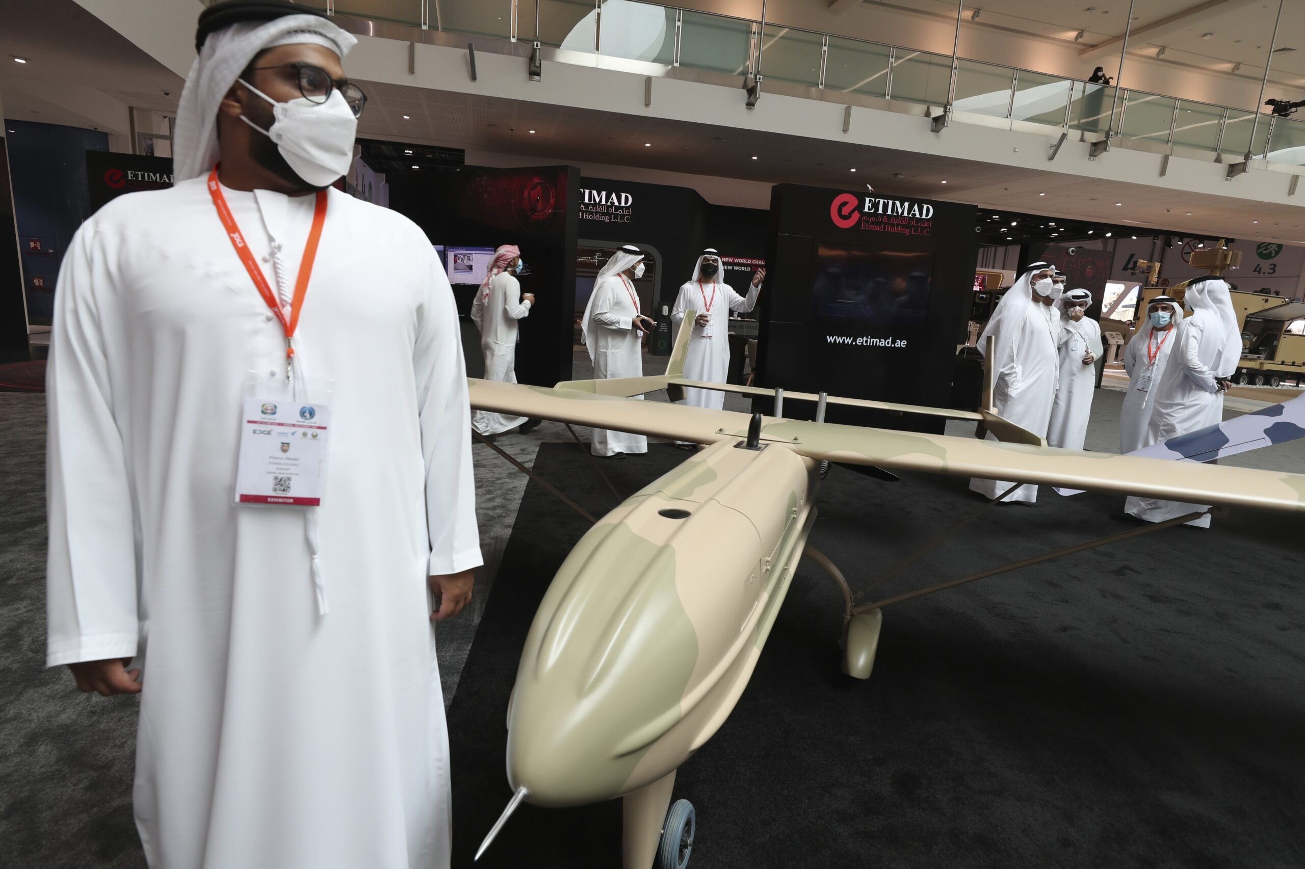 Visitors and officials pass by a combat drone from Etmad, an Emirati company, during the opening day of the International Defence Exhibition and Conference (IDEX) in Abu Dhabi, United Arab Emirates, Sunday, Feb. 21. (AP Photo/Kamran Jebreili)