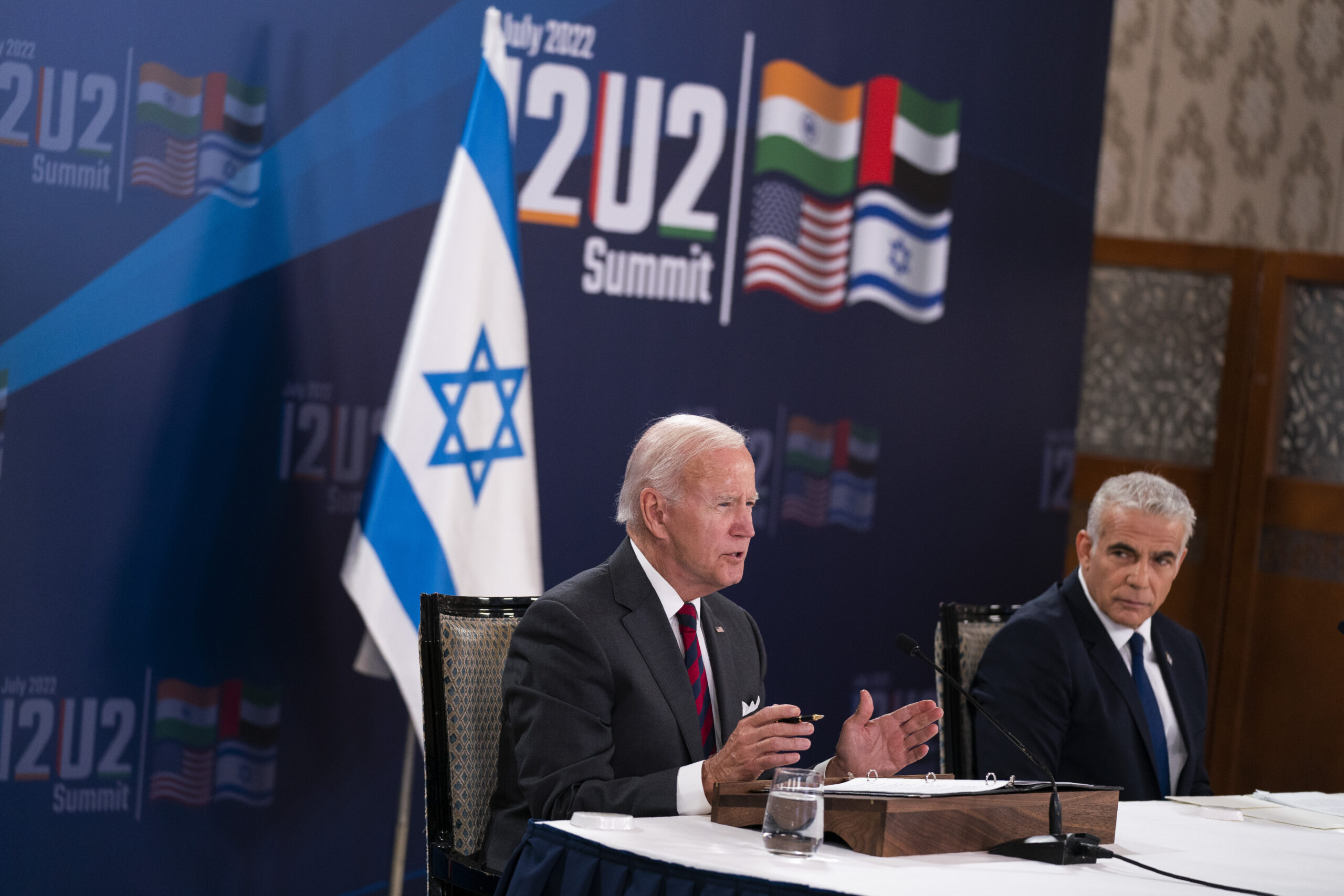 Israeli Prime Minister Yair Lapid listens as President Joseph R. Biden Jr. speaks during a virtual summit with the leaders of India and the United Arab Emirates, July 14. (AP Photo/Evan Vucci)