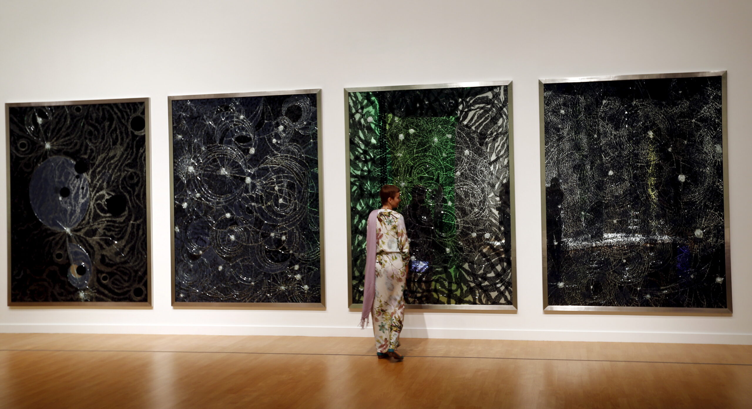 A tourist looks at art by Bharti Kher from the Seeing Through Light selections from the Guggenheim Abu Dhabi collection at the Manarat Al Saadiyat Gallery in Abu Dhabi November 27, 2014. (REUTERS/Caren Firouz)