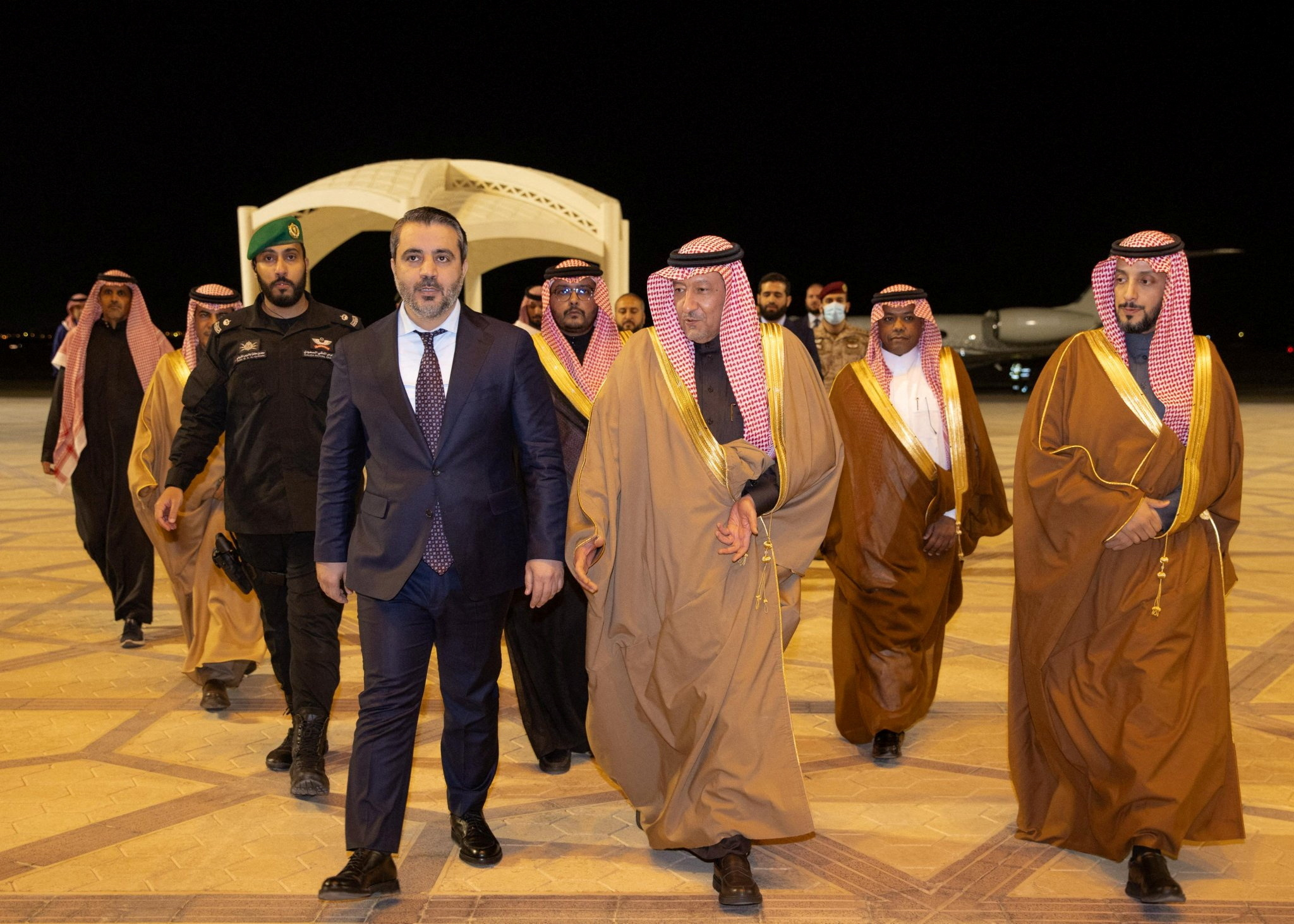 Syria's newly appointed foreign minister, Asaad Hassan al-Shibani, walks with Saudi Deputy Foreign Minister Waleed Elkhereiji as he is welcomed upon his arrival in Riyadh, Saudi Arabia, January 1. (Saudi Press Agency/Handout via REUTERS)