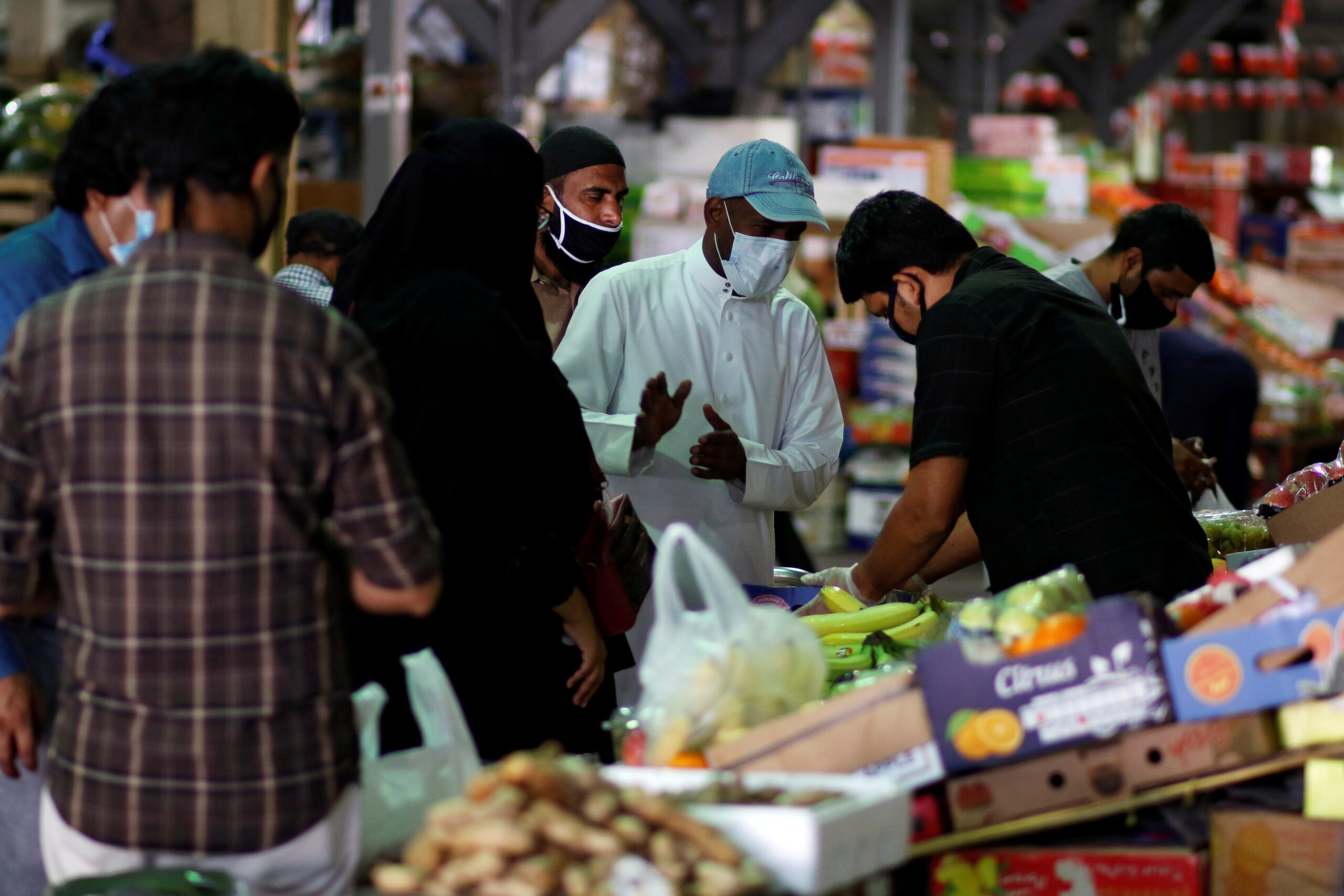 People wear protective face masks following the outbreak of the coronavirus disease, as they shop at a market in Manama, Bahrain, April 23, 2020. (REUTERS/Hamad I Mohammed)