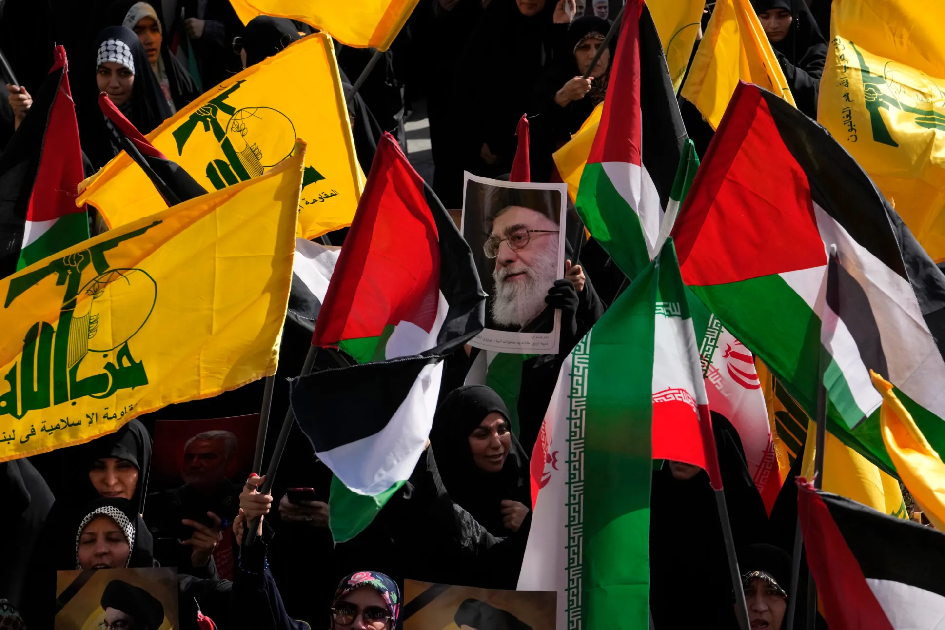 Demonstrators hold Iranian, Palestinian, and Hezbollah flags and a poster of Iranian Supreme Leader Ayatollah Ali Khamenei in a rally commemorating slain Hezbollah leader Hassan Nasrallah, in Tehran, Iran, Oct. 2, 2024. (AP Photo/Vahid Salemi)