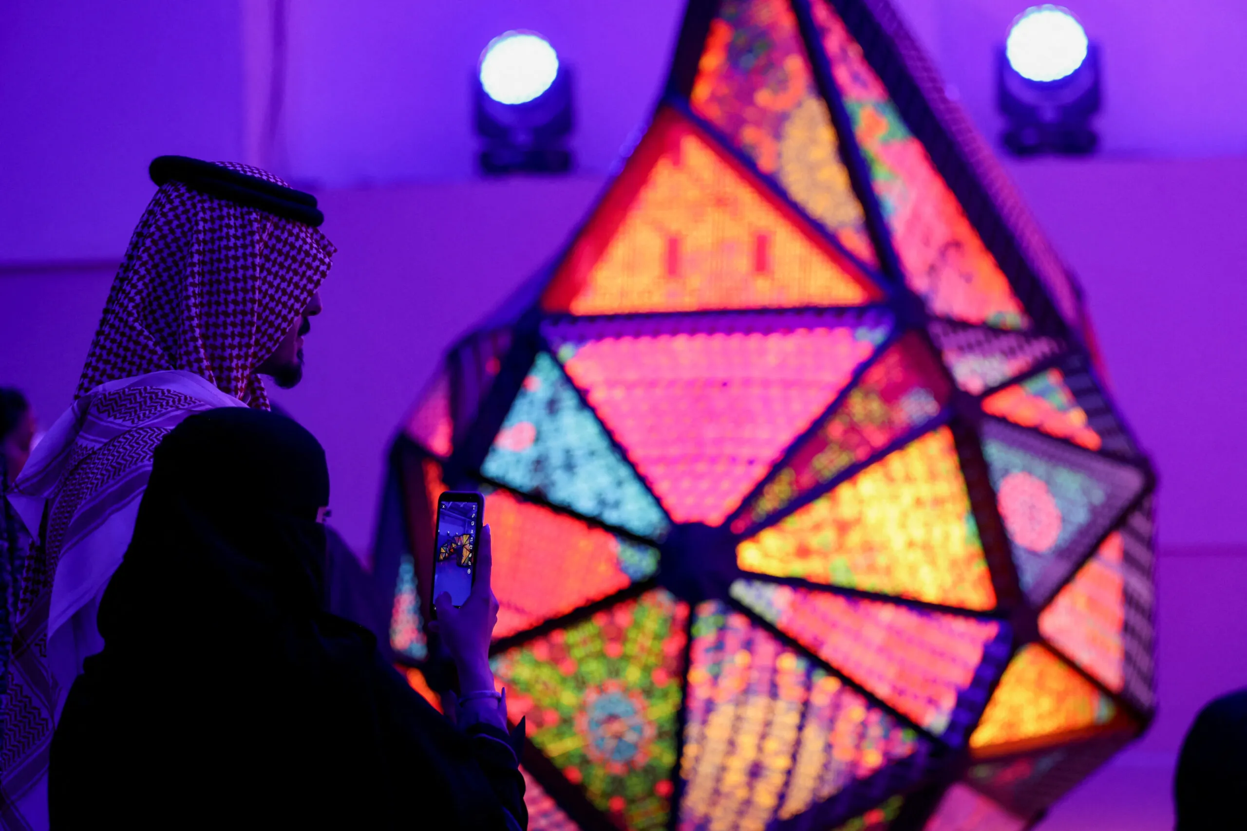 A visitor takes photos of an art piece at the Jax Art Festival, Riyadh, Saudi Arabia, July 20, 2022. (REUTERES/Ahmed Yosri)